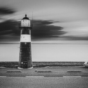 Greyscale Shot Lighthouse Road with Van Side Sea